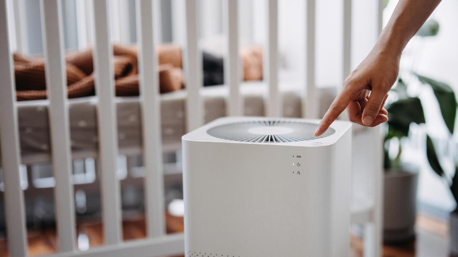 A woman turning on the air purifier