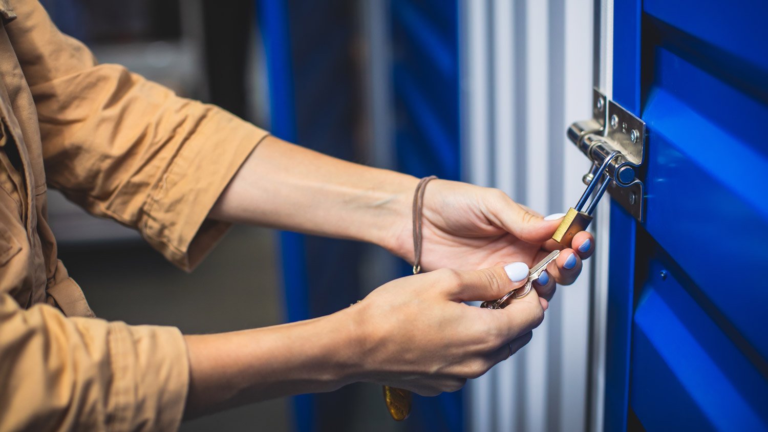 Close-up of a woman unlocking a storage unit