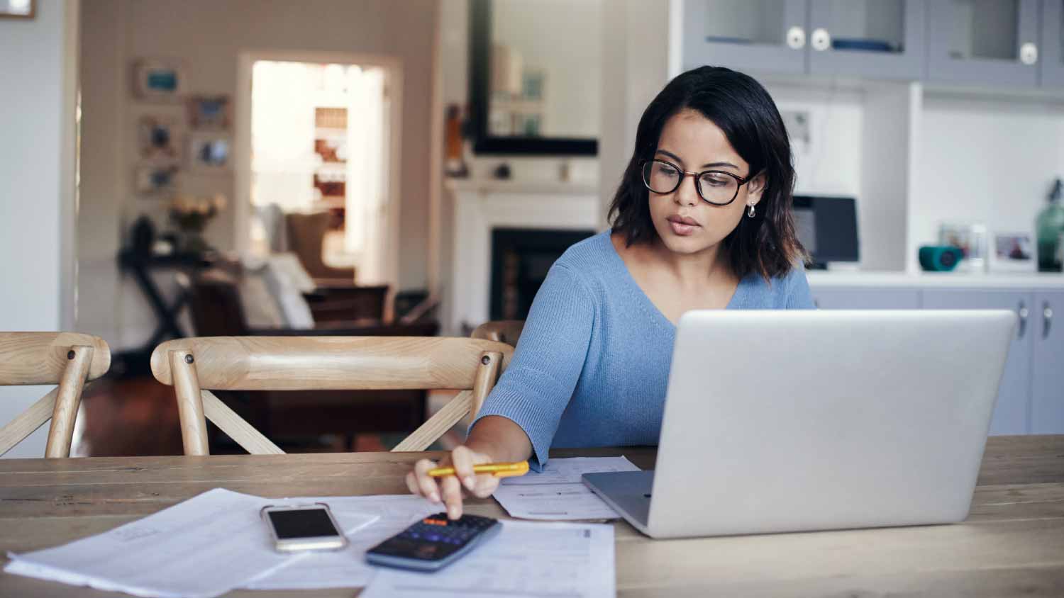 Woman using a laptop and calculator