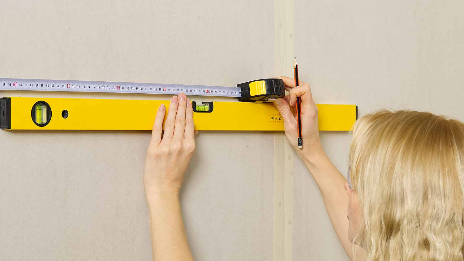 woman using spirit level to work