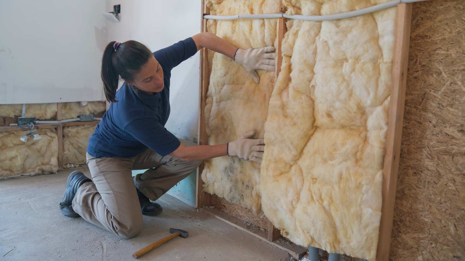 woman insulating wall