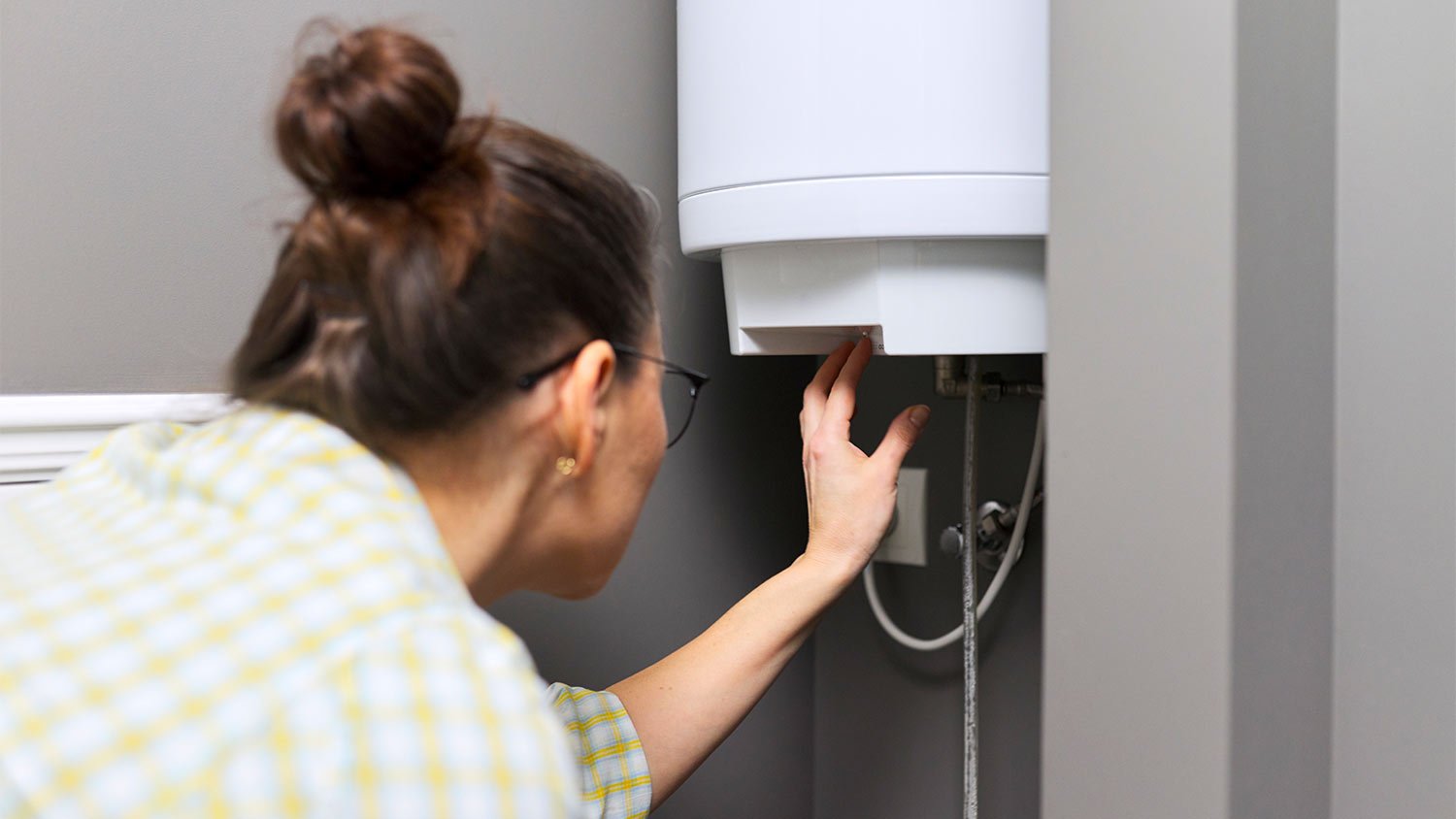 woman looking at hot water heater 