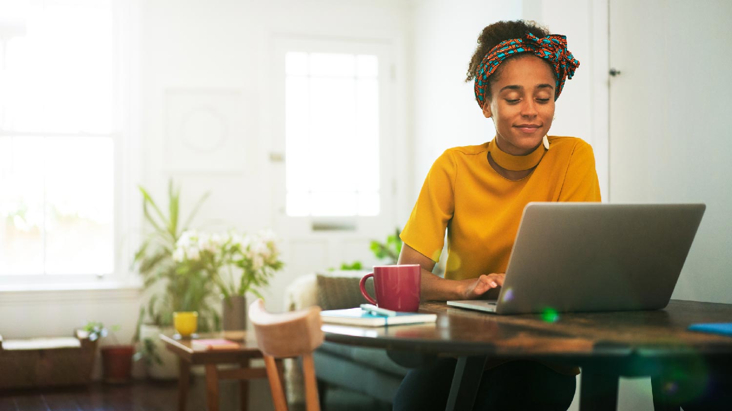 A woman working on her laptop from a home office