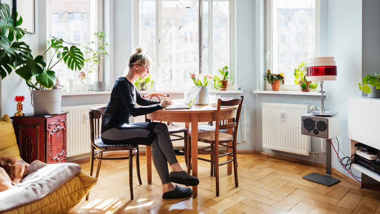 A woman working remotely from her apartment