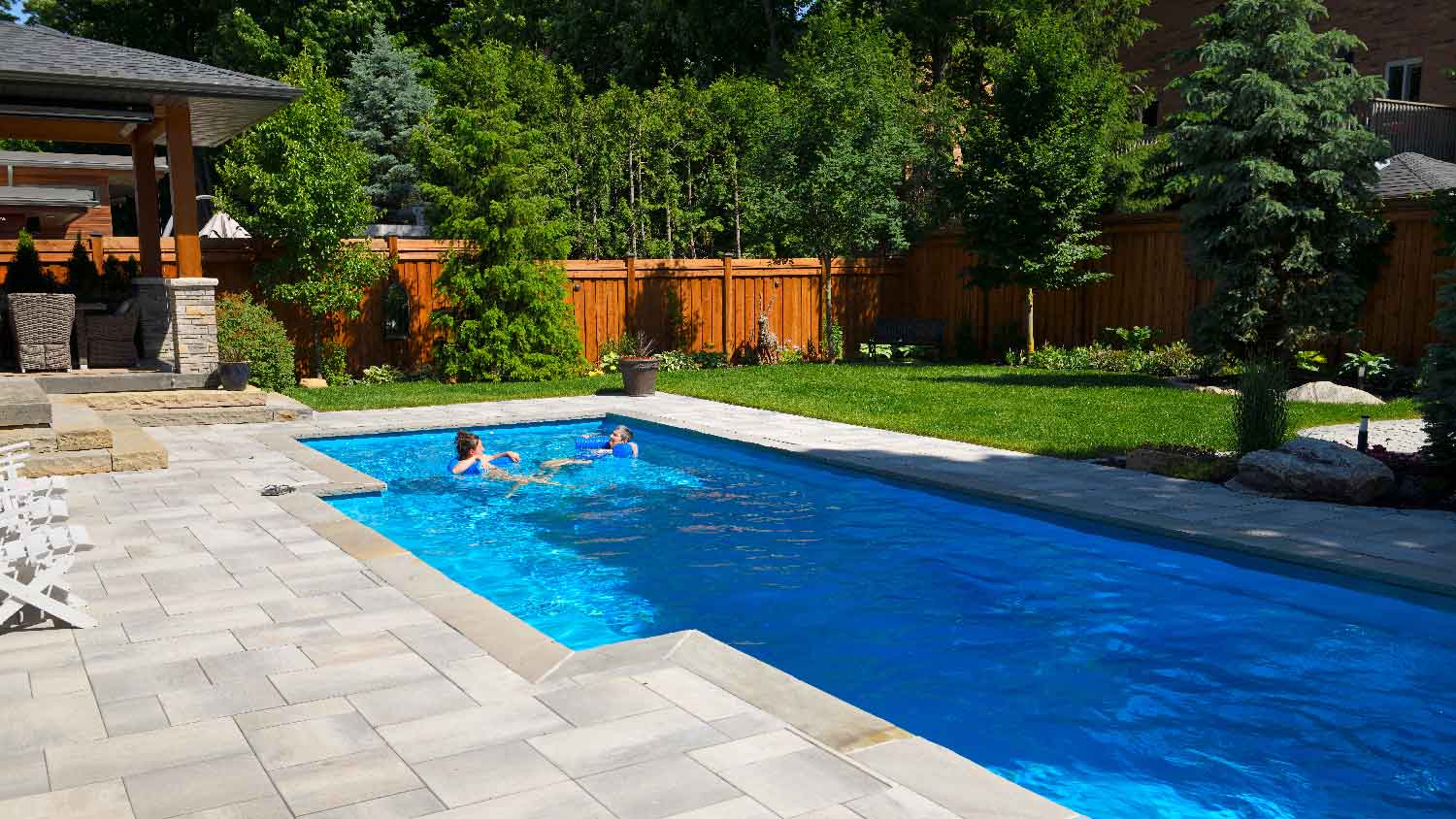 Two women relaxing in a fiberglass pool