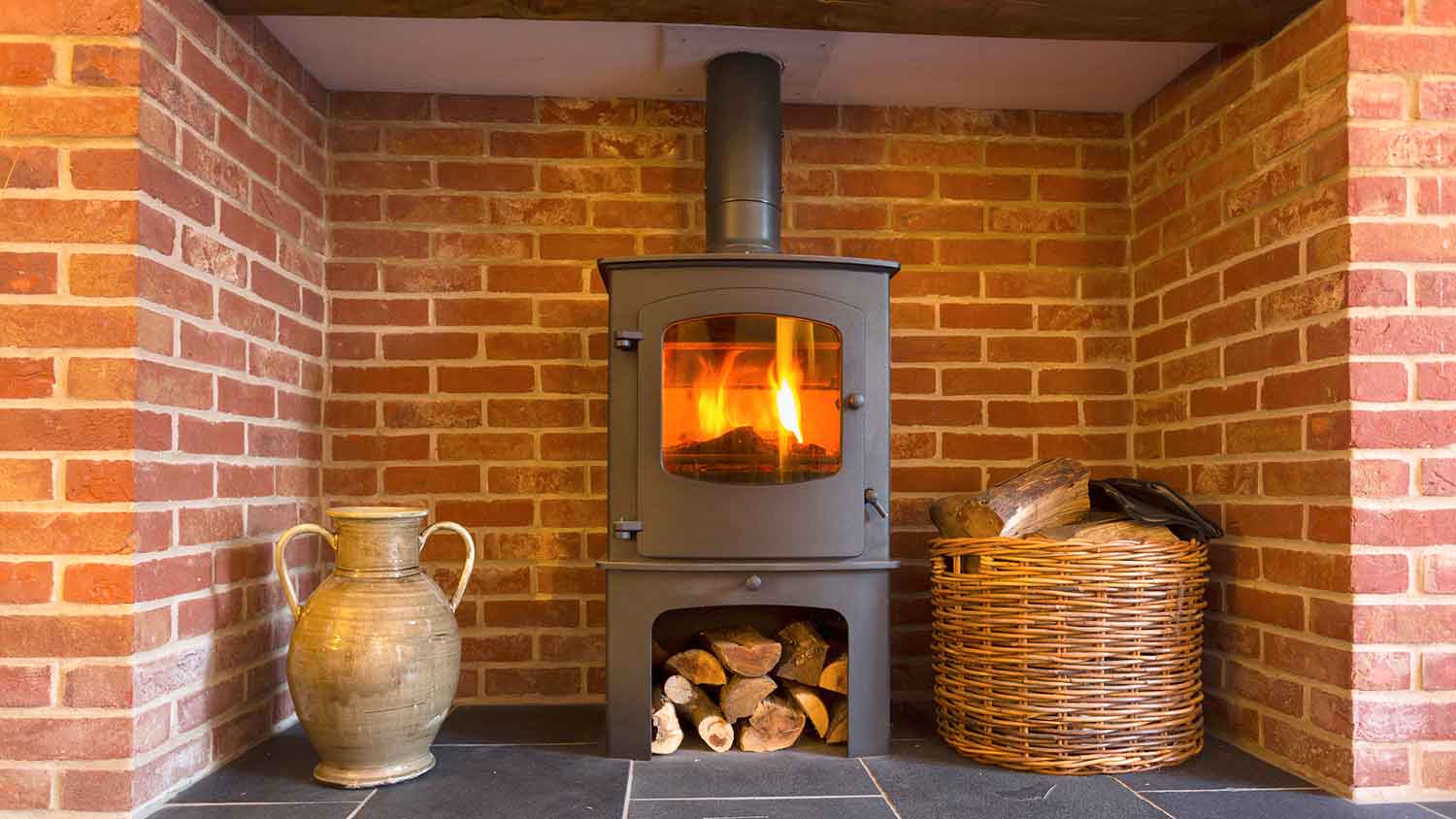 Wood burning stove installed in a brick fireplace