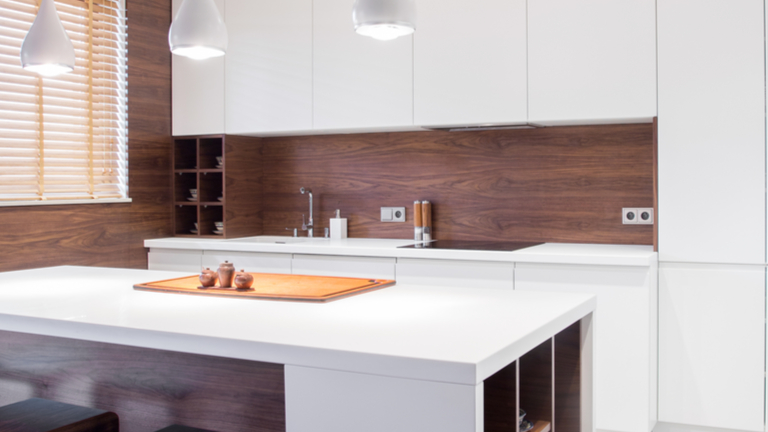 Dark wood backsplash in white kitchen