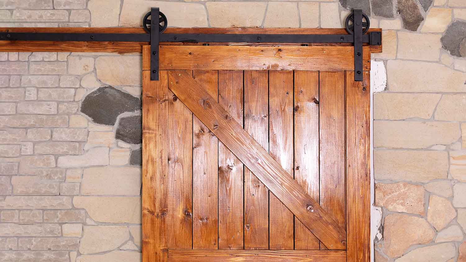 Wooden barn door with sliding mechanism