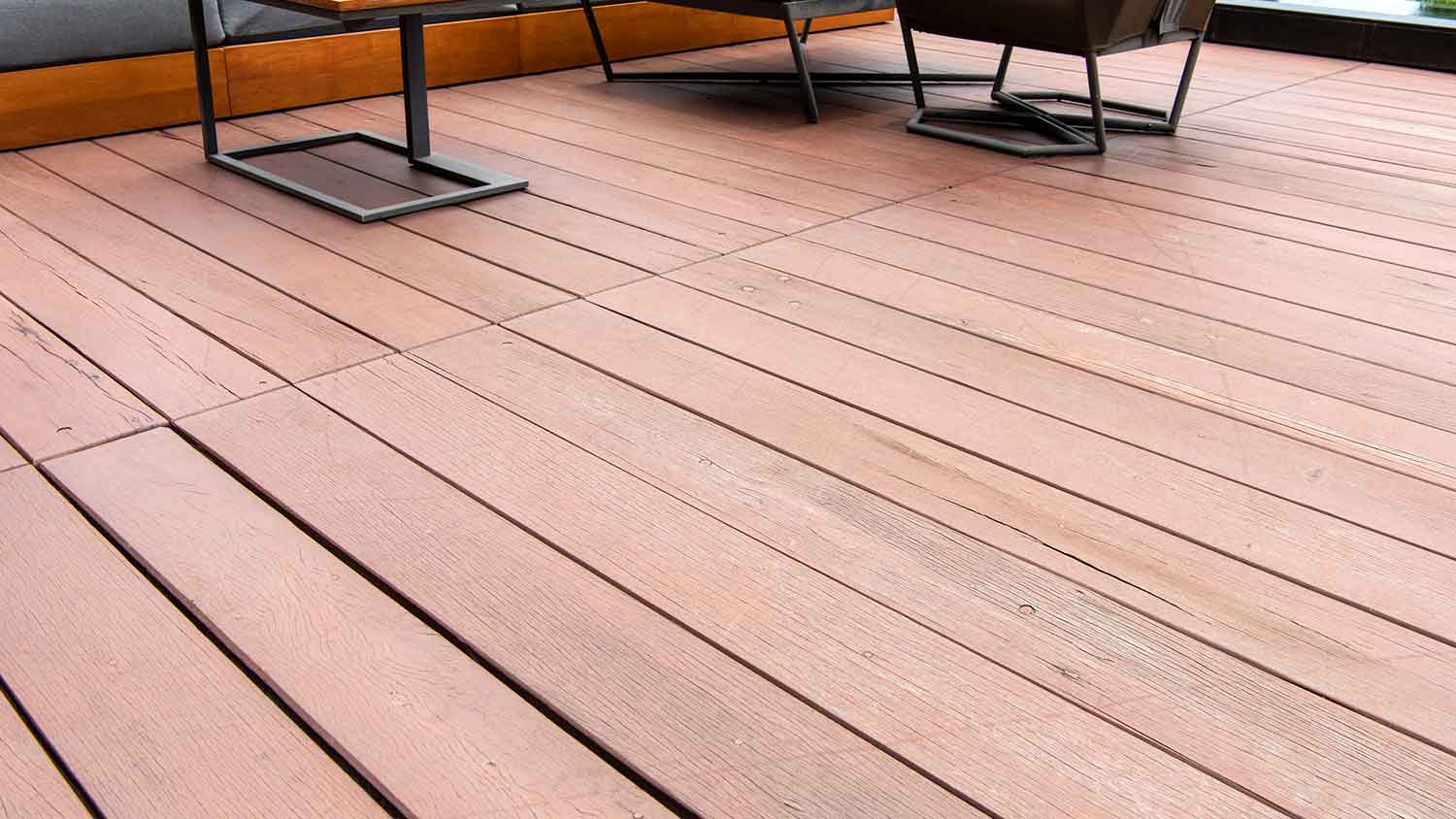 Patio deck with wooden decking attached to the building