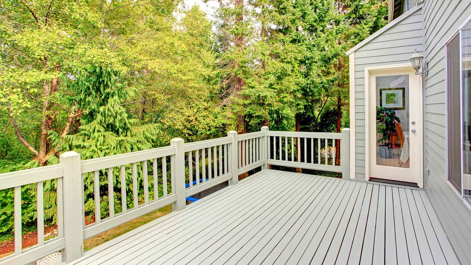 Walk-out deck with wooden railing balusters