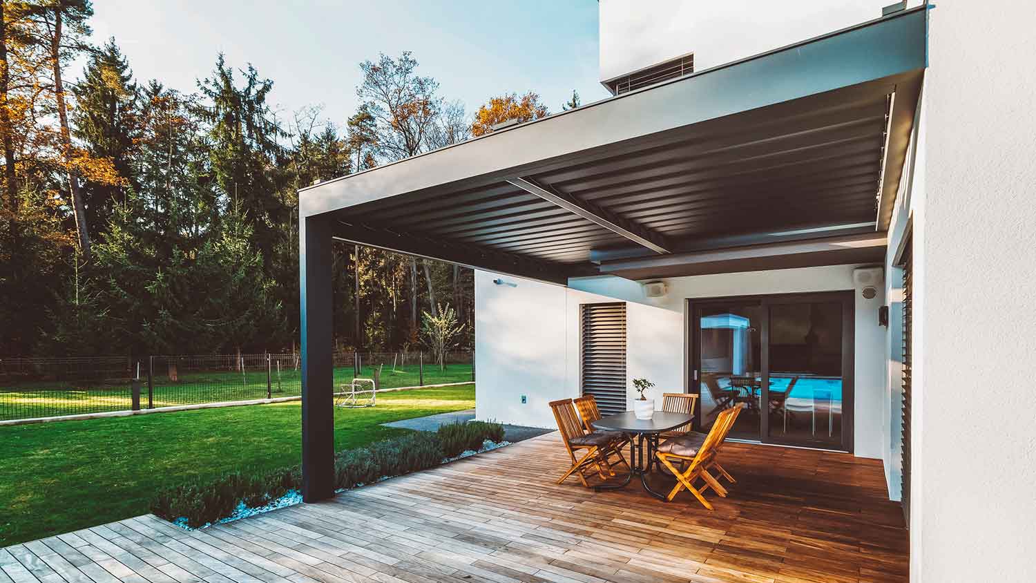 A wooden patio overlooking the backyard of a house