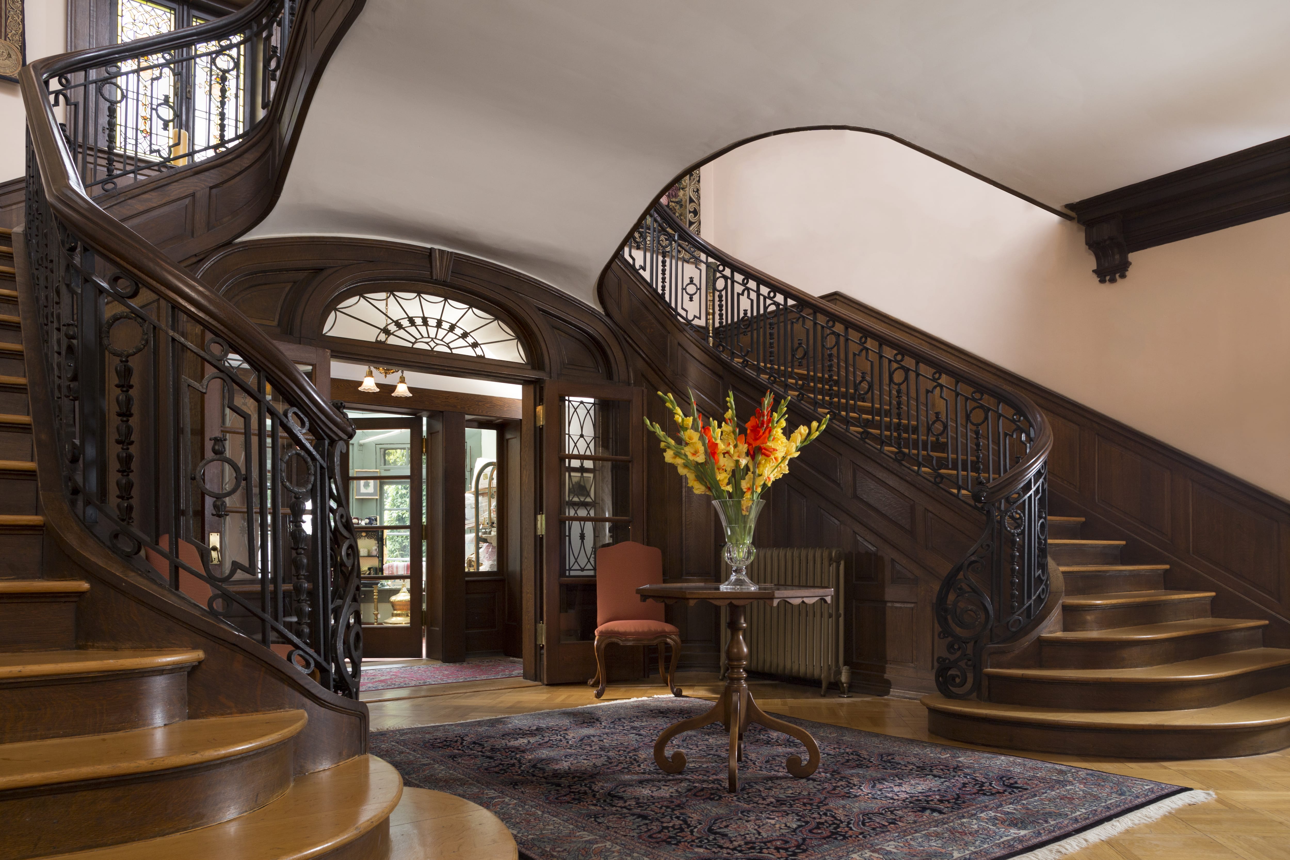 Double curved staircase in grand foyer area