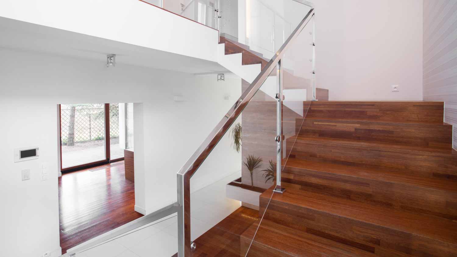 Wooden stairs with elegant railing glass 