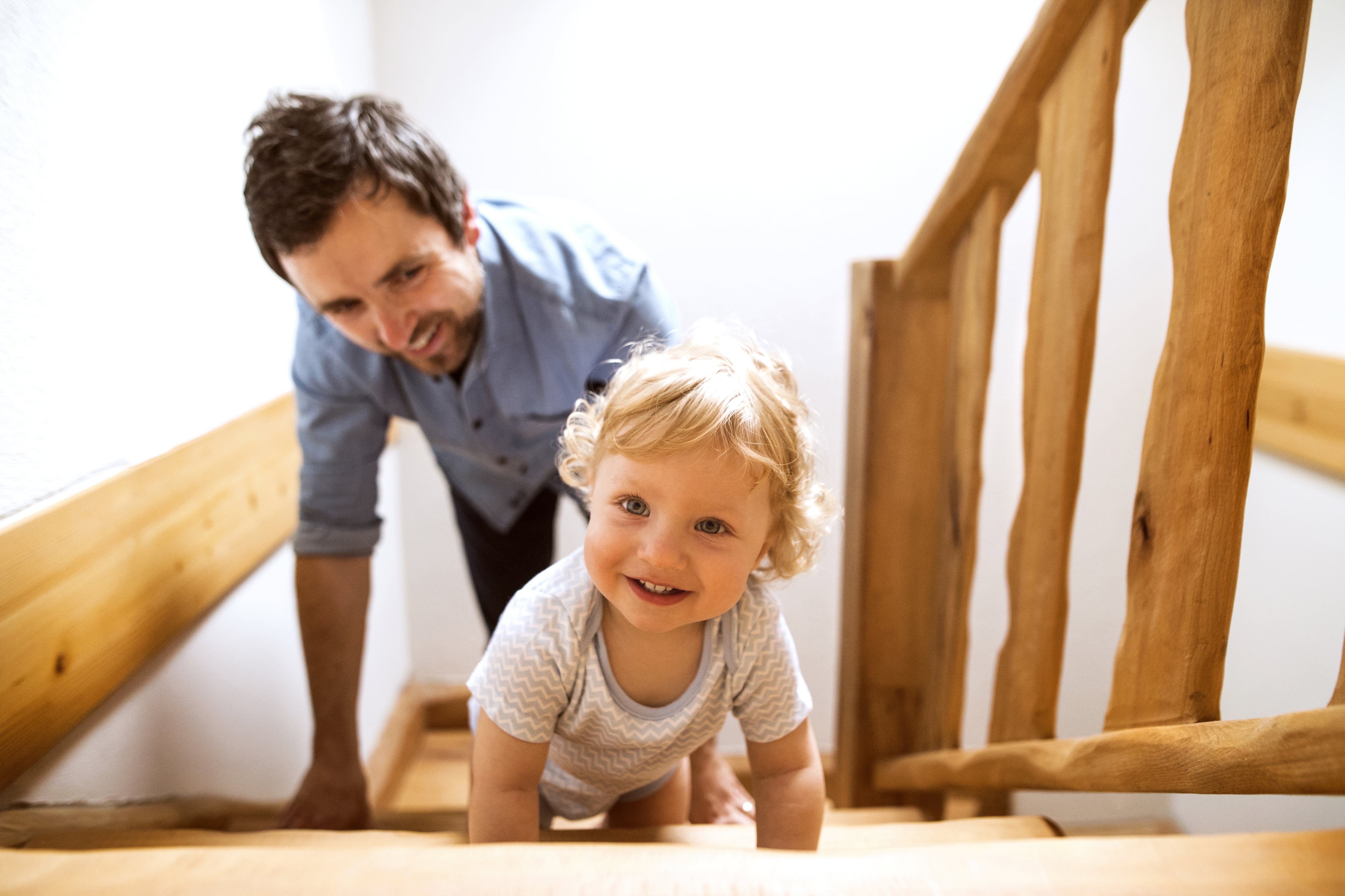 Father and son playing on wooden stairs