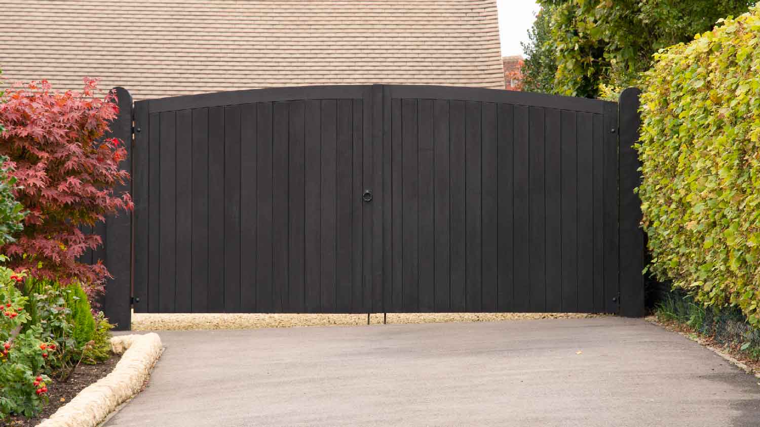 A black wooden swing automatic gate