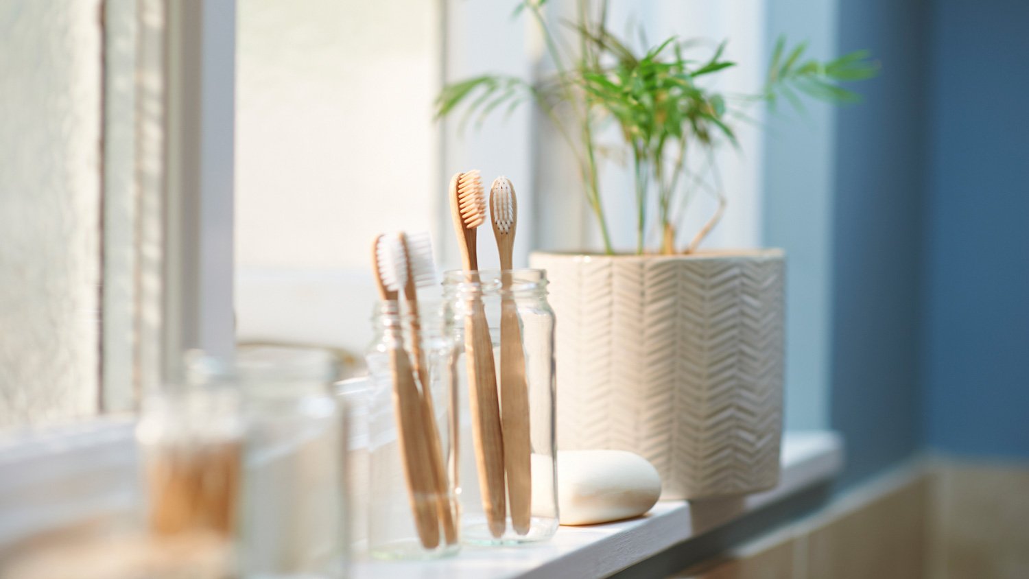 Wooden toothbrushes and other toiletries in a guest bathroom