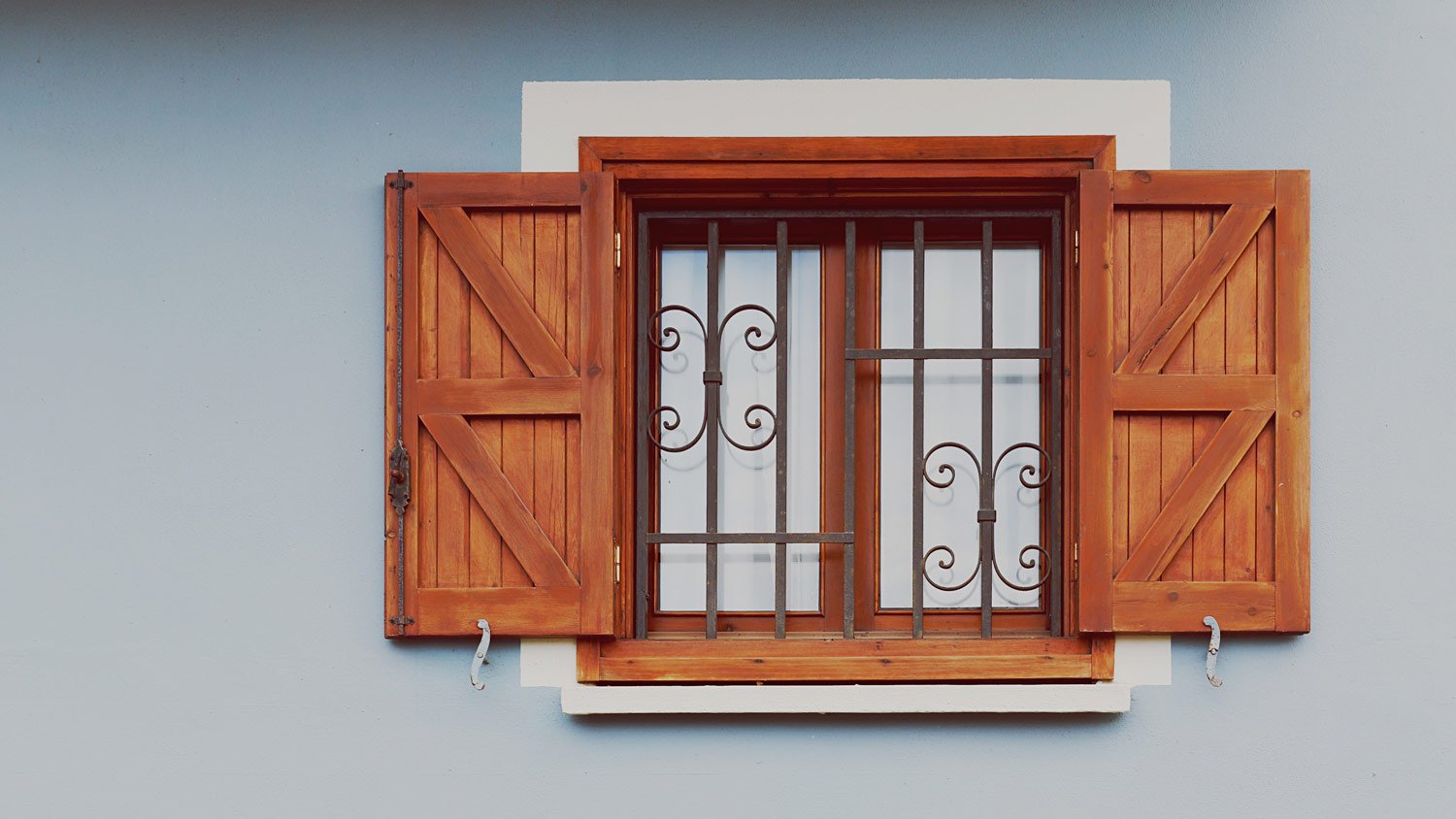 Close-up of a window with wooden shutters 