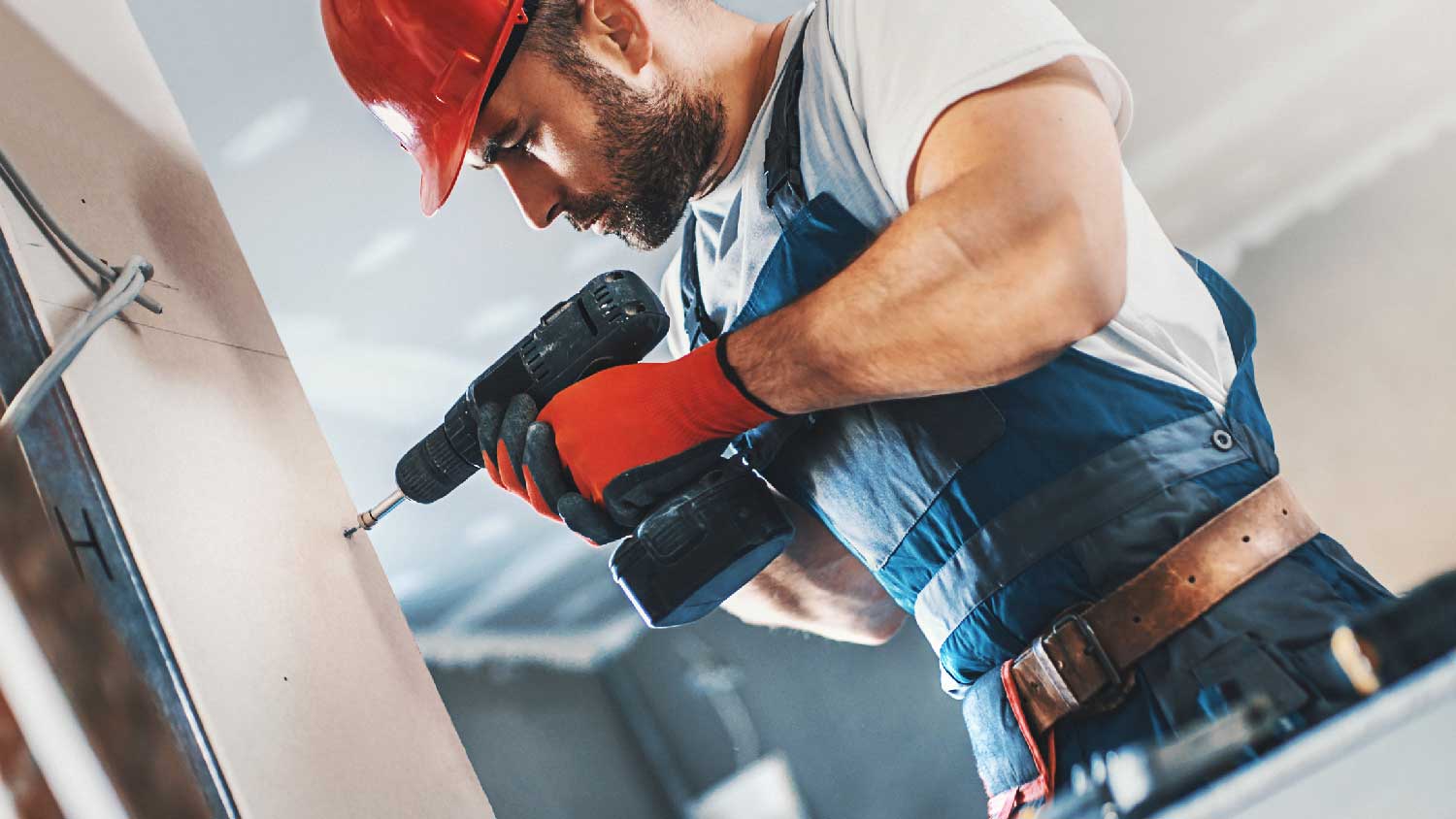 A worker assembling a drywall