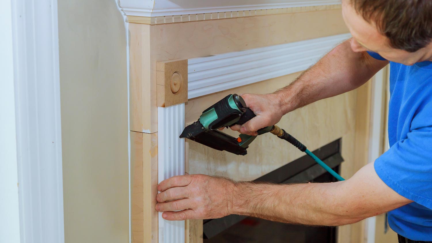 A worker fixing a fireplace