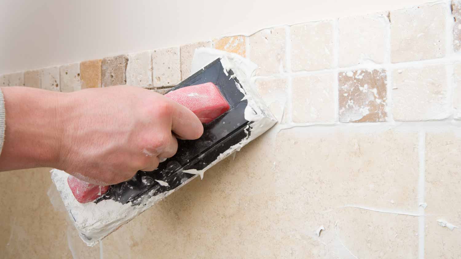 A worker grouting tiles