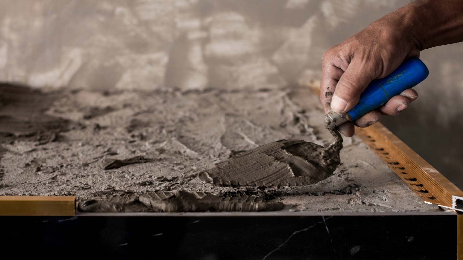 A worker installing a concrete countertop