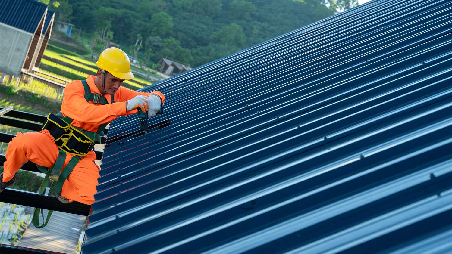 Worker installing new metal roof