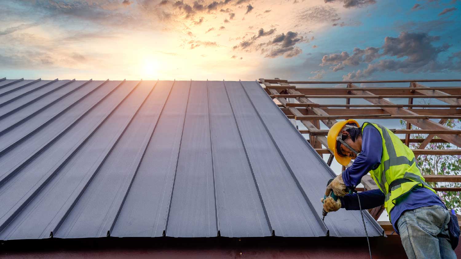 A worker installing a steel roof