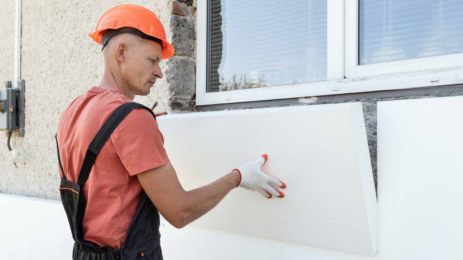 Worker is installing a styrofoam board