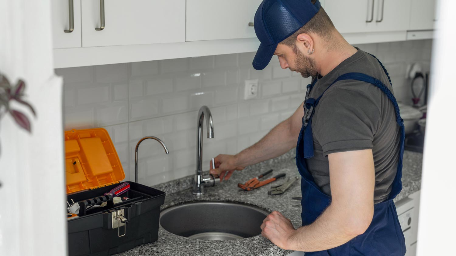 A worker making sure the faucet is unplugged