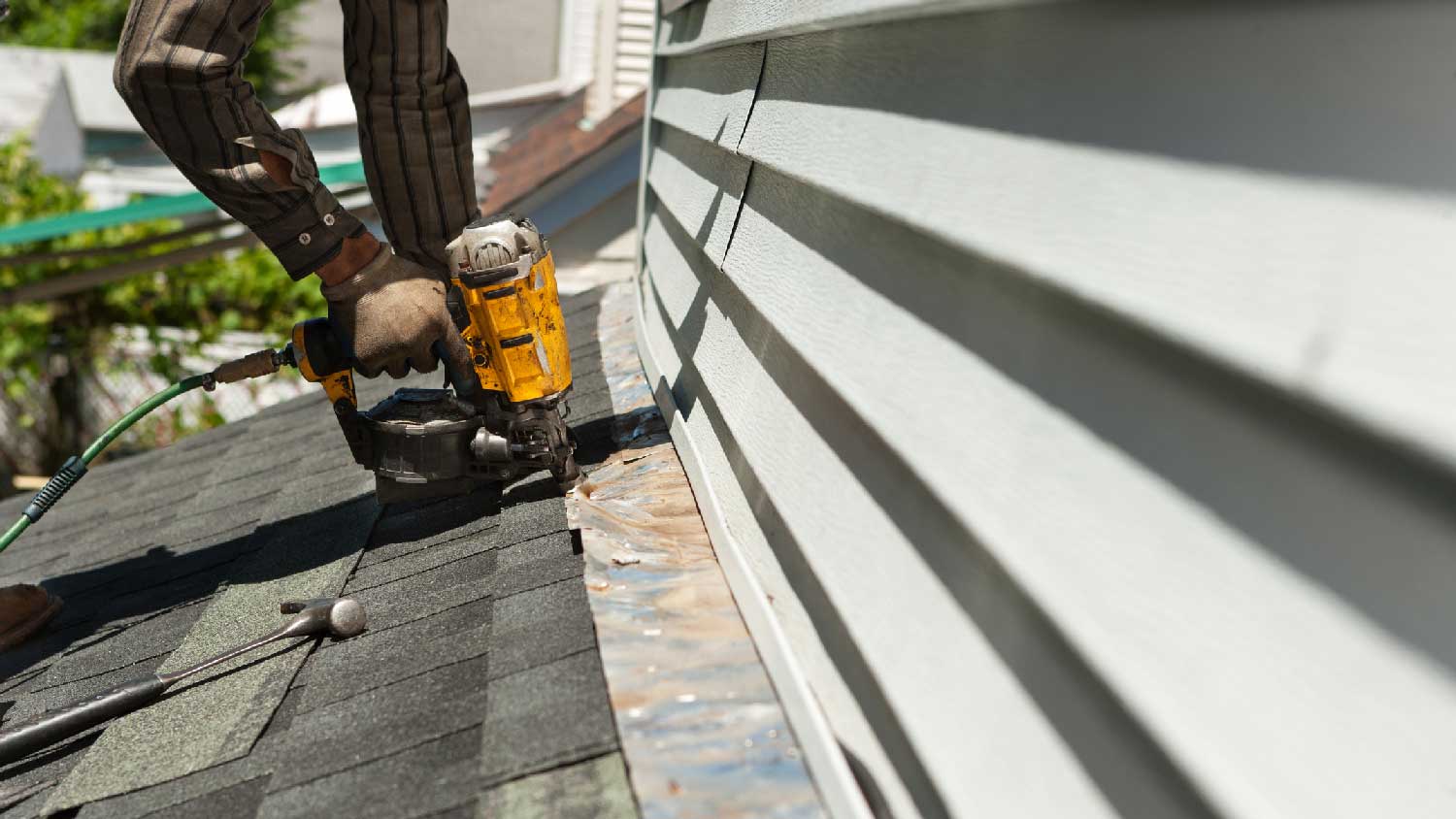 A worker replacing a copper strip on the roof