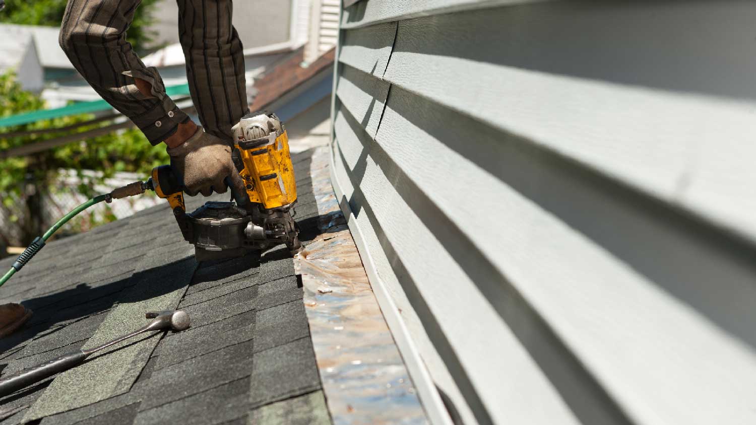 A worker replacing a copper strip on the roof 