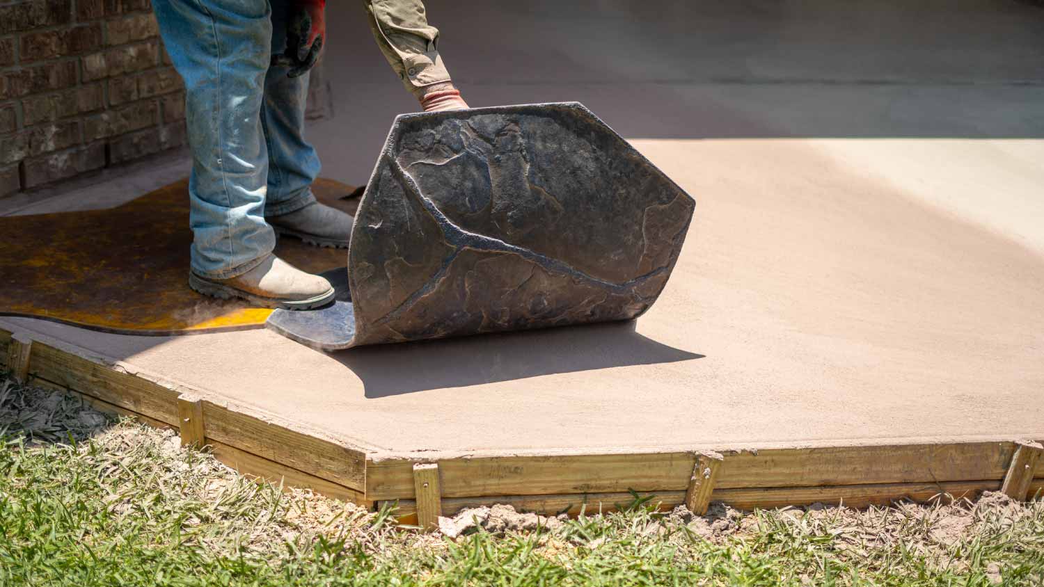 worker stamping concrete