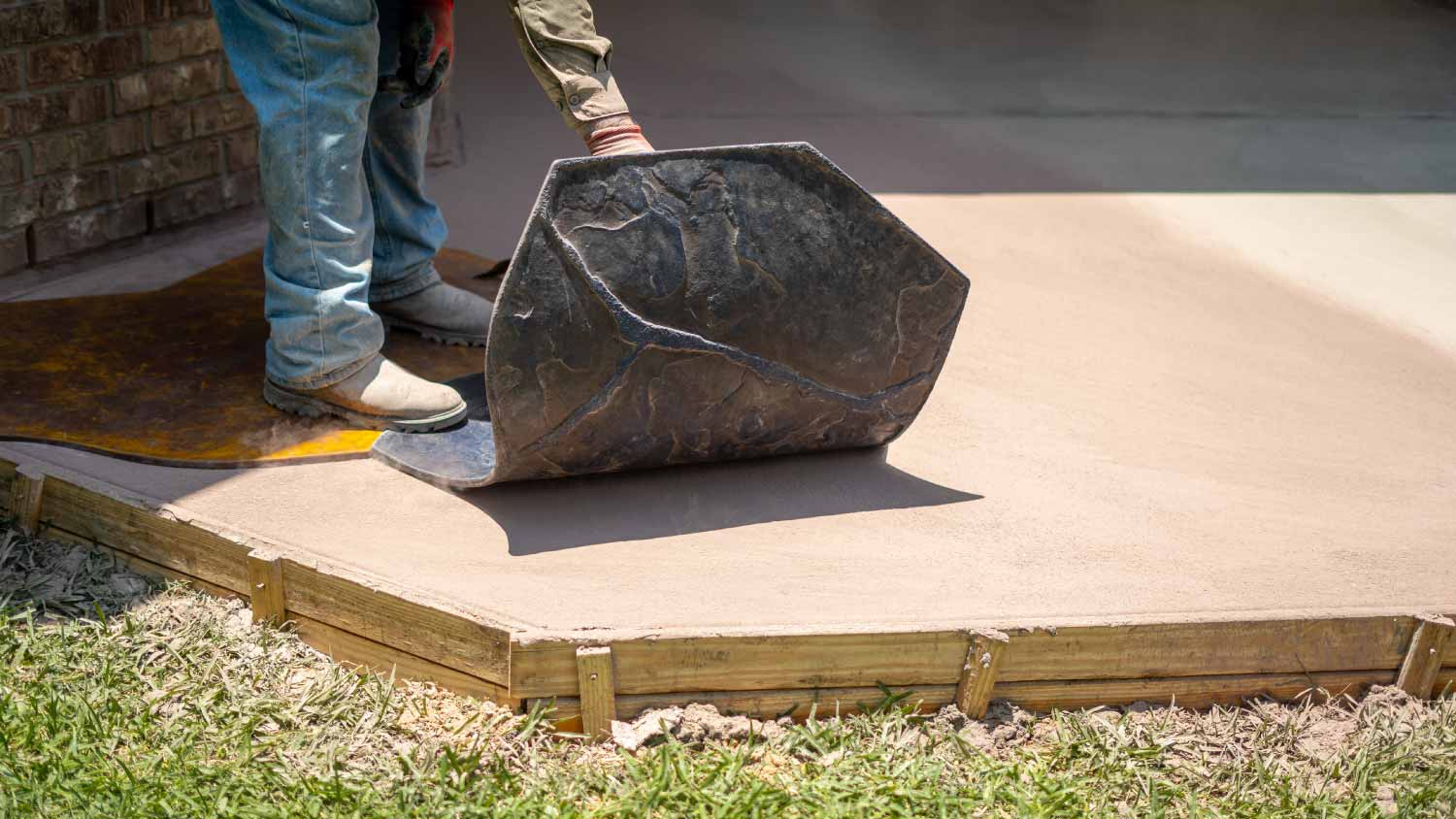 worker stamping concrete  