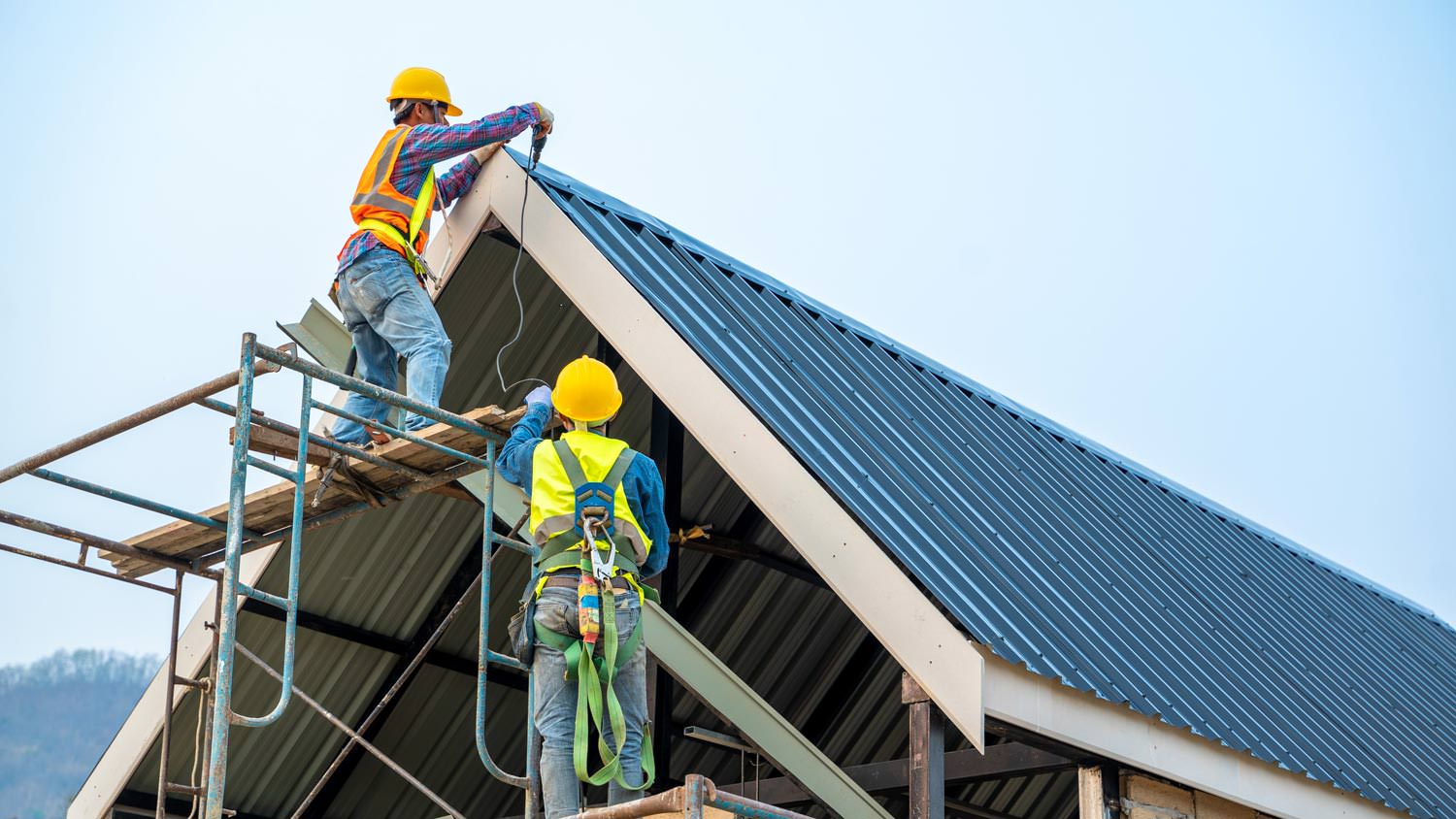 Workers installing a new metal roof