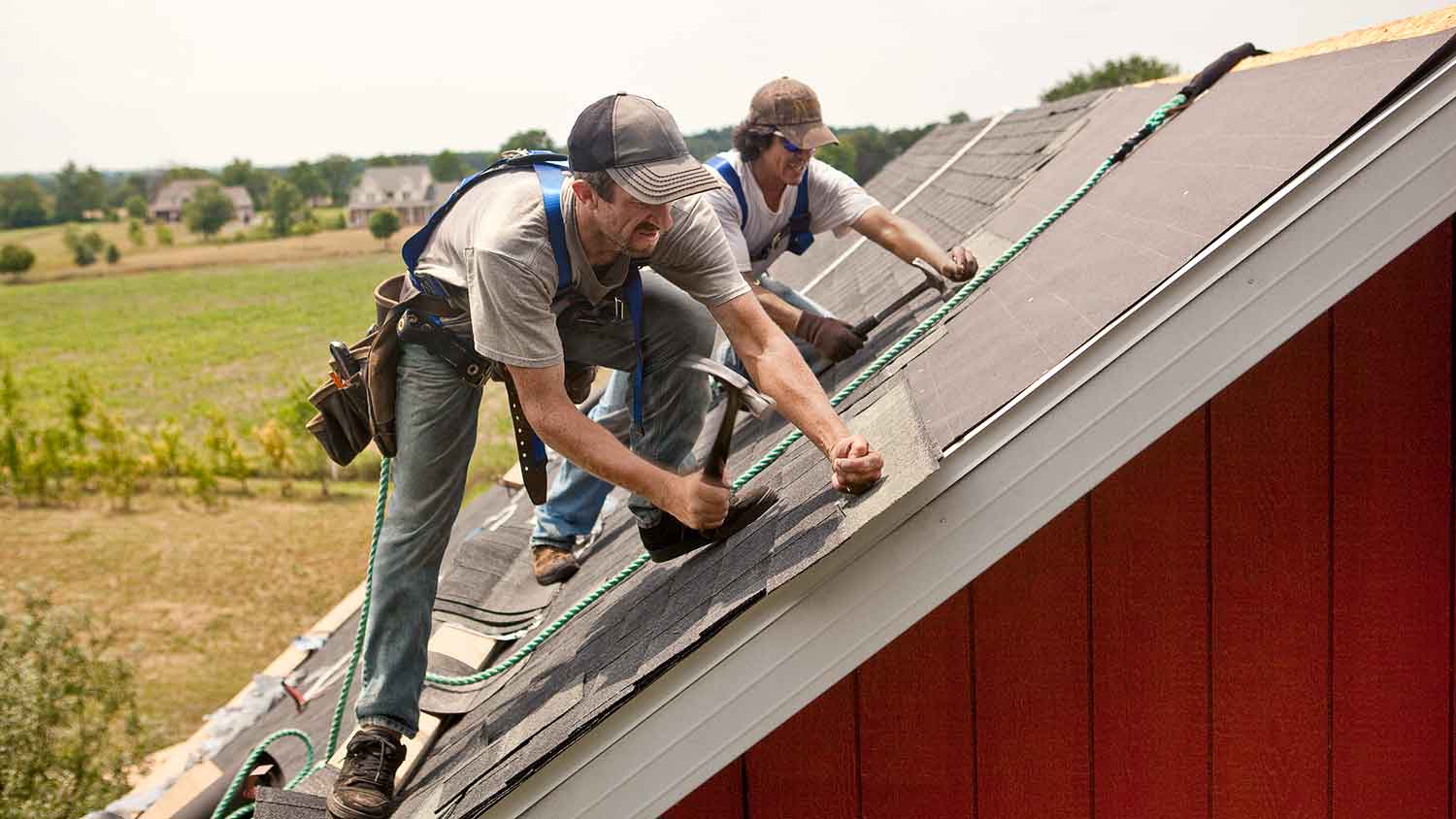 Roof professionals installing new shingles on the roof  