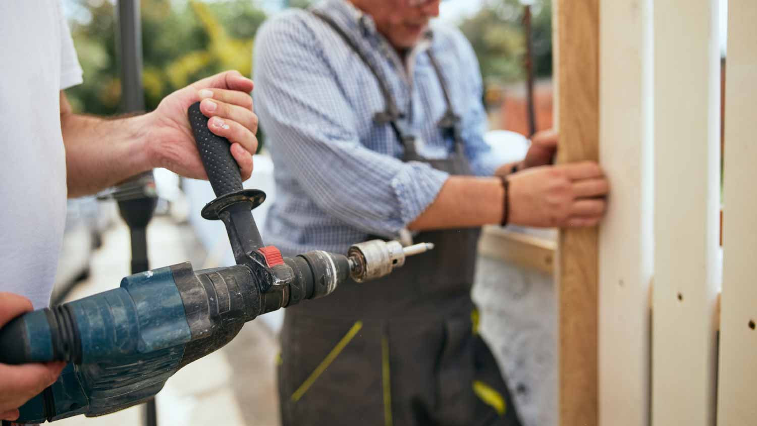 workers installing a wooden fence