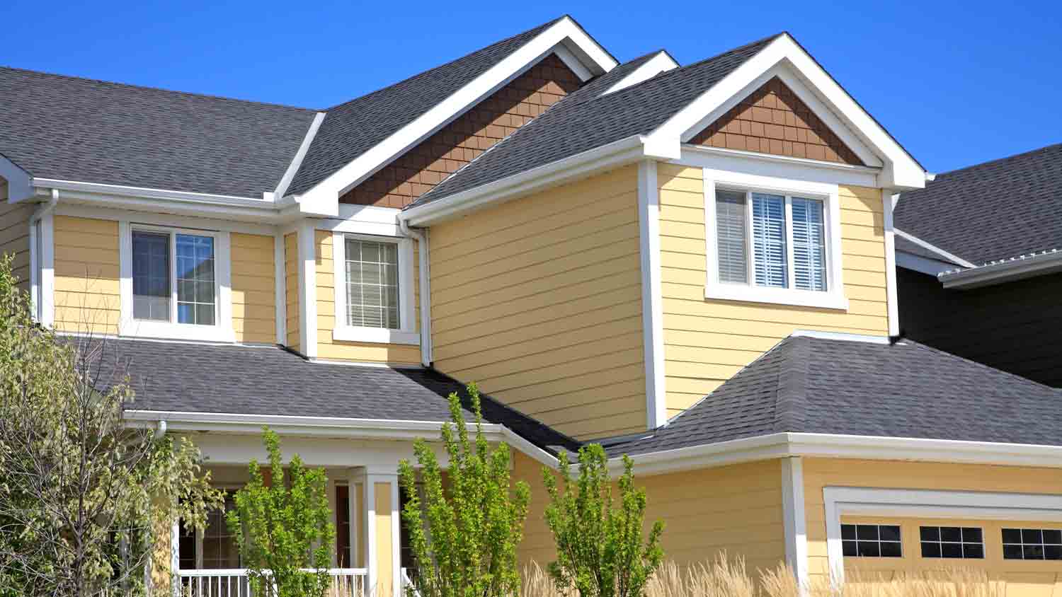 yellow and grey two story house
