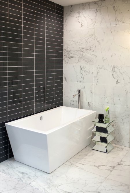 black tile with marble and soaker tub in bathroom
