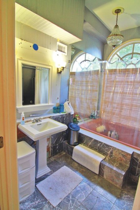 Featured on HGTV, Atlanta homeowner Brad Crosby's bathroom remodel includes a spa-like shower and a heated limestone floor with marbel accents. (Photo courtesy of Stephen Weatherby)