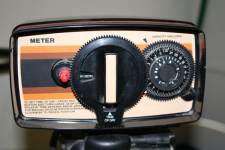 To adjust the time on a Fleck water softener, press the red button on the left side of the softener head and turn the dial, says LeGault. (Photo courtesy of Peterson Salt & Water Treatment)