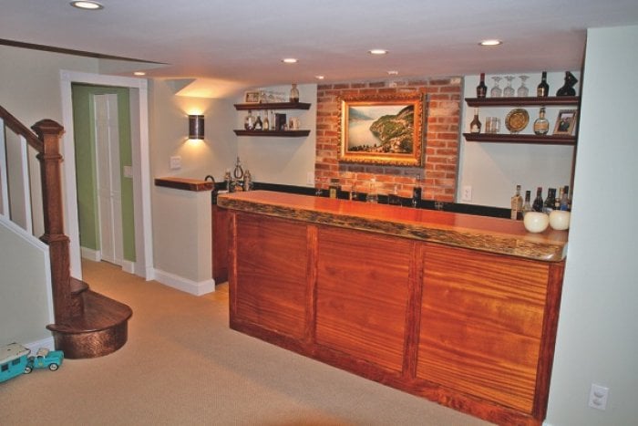 custom-built wood bar with trim in finished basement
