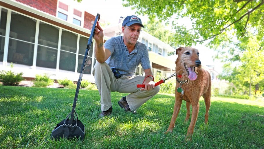 man with dog and pooper scooper