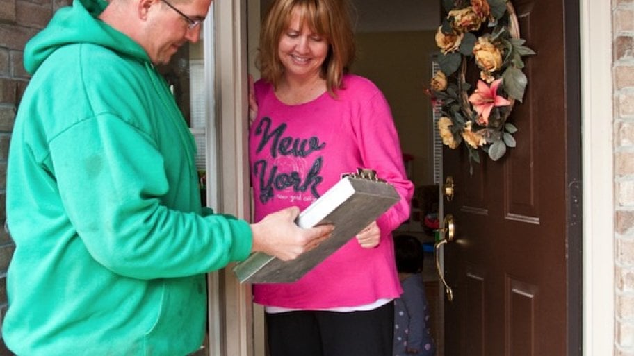 contractor gives home improvement estimate to woman