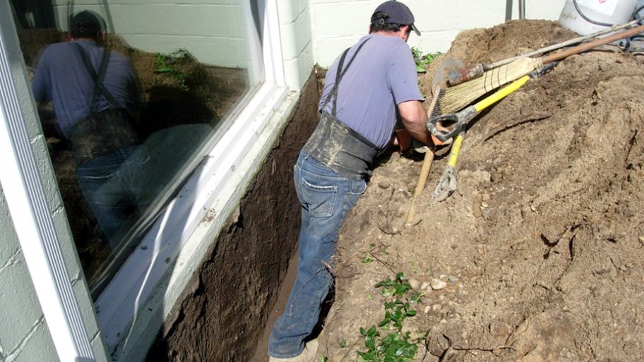 basement waterproofing contractor working