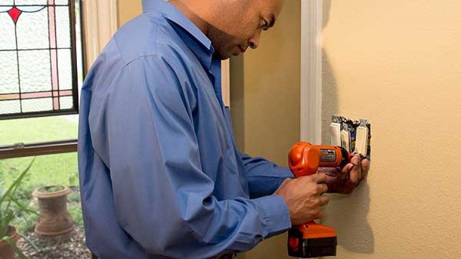 electrician working on light switch