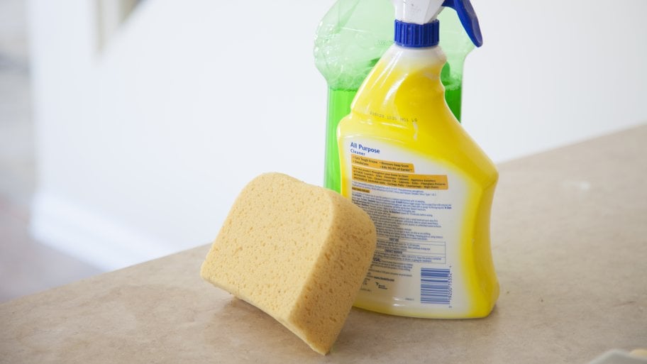 sponge on counter with cleaning products
