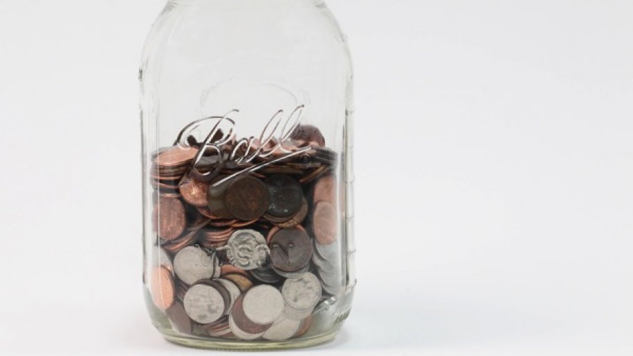 a mason jar containing coins.